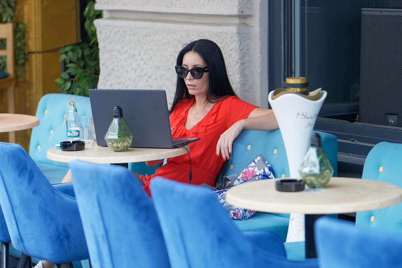 woman, work from anywhere, cafe, working, casual, sunglasses, stand, outdoor, laptop, remote work, lifestyle, remote work, remote work, remote work, remote work, remote work on The Anywhere Office